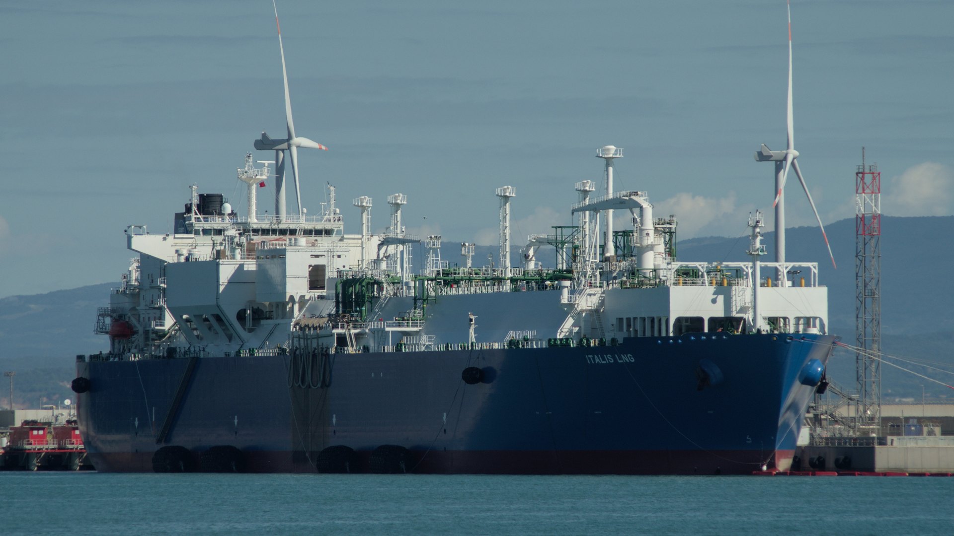 An LNG carrier berthed at a gas terminal