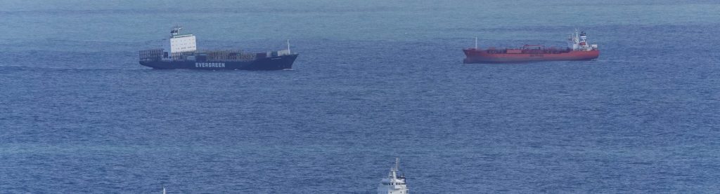 Cargo vessels lying at anchor in the roads
