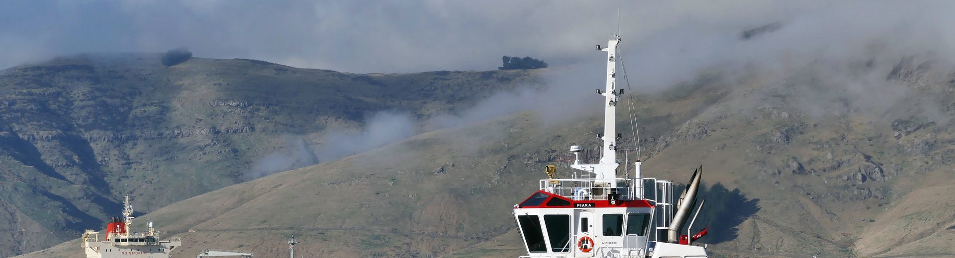 Harbour tug alongside a tanker